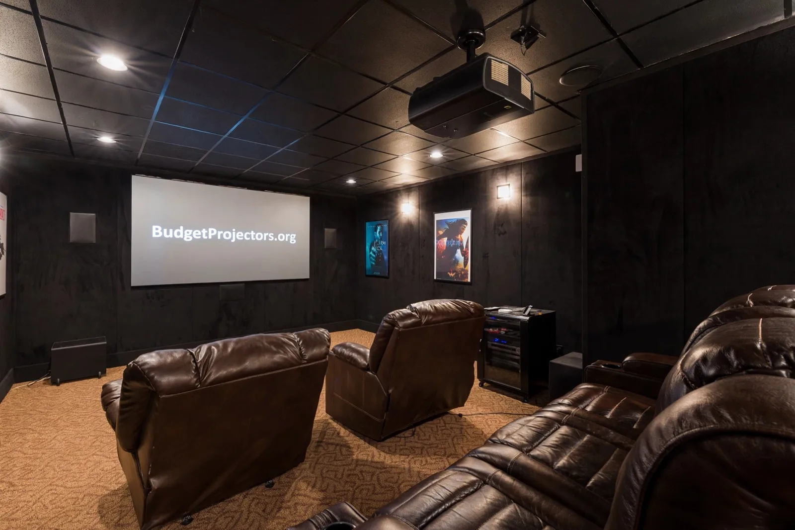 Dedicated home theater with ceiling-mounted projector and large projection screen