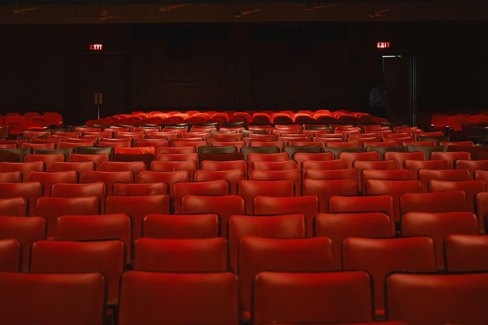 Dark vintage cinema with rows of red seats